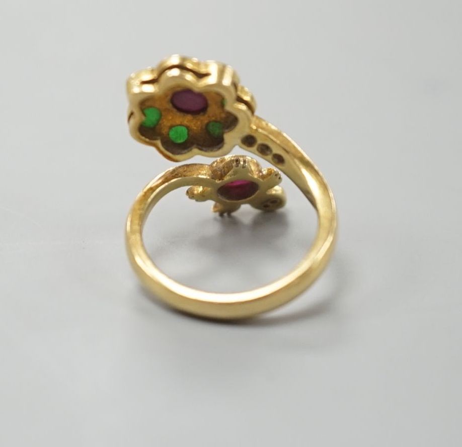 A modern Thai yellow metal and gem set 'Turtle and flower head' crossover ring, size F, gross weight 4.7 grams.